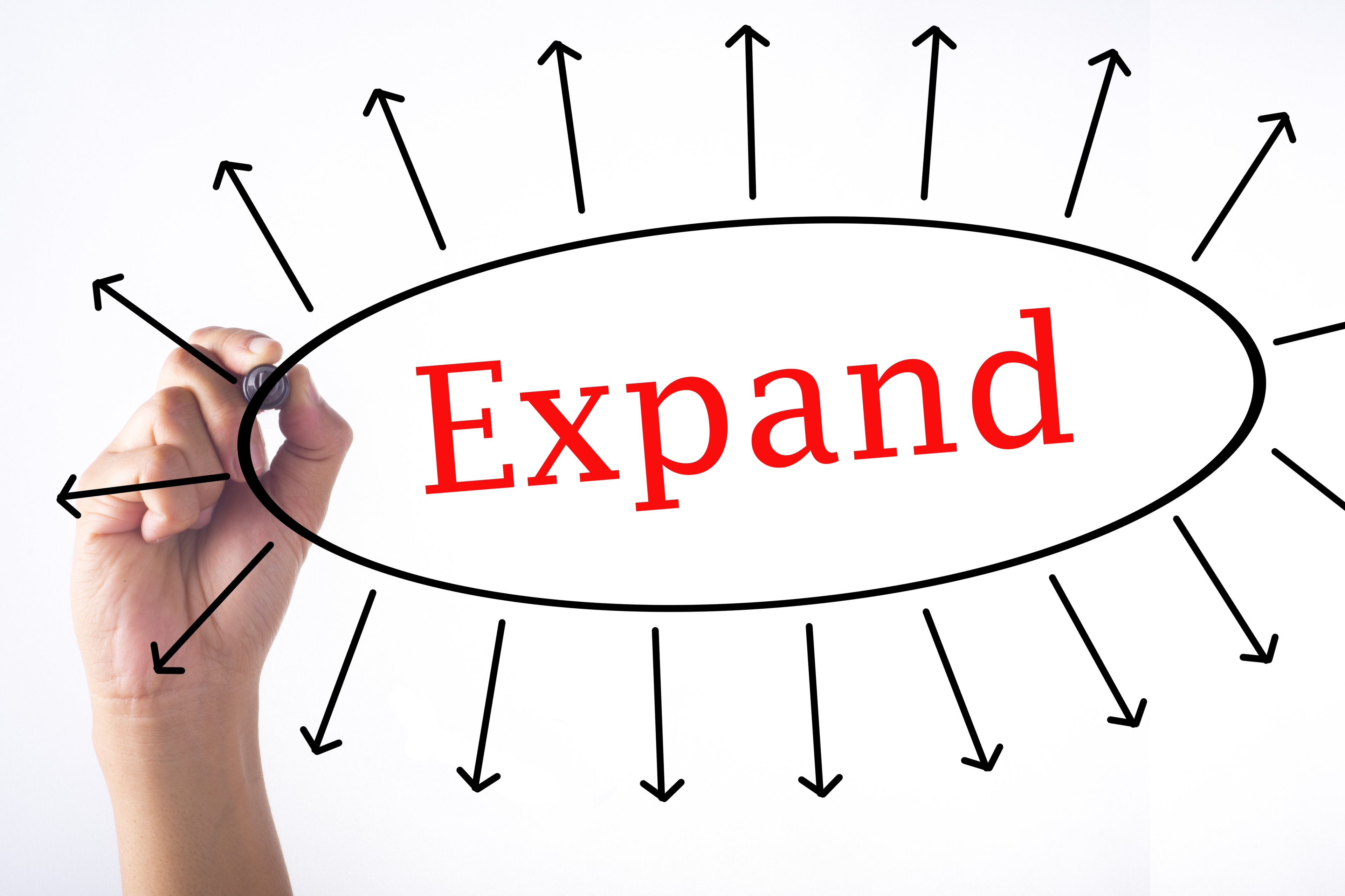 Person drawing the word expansion.